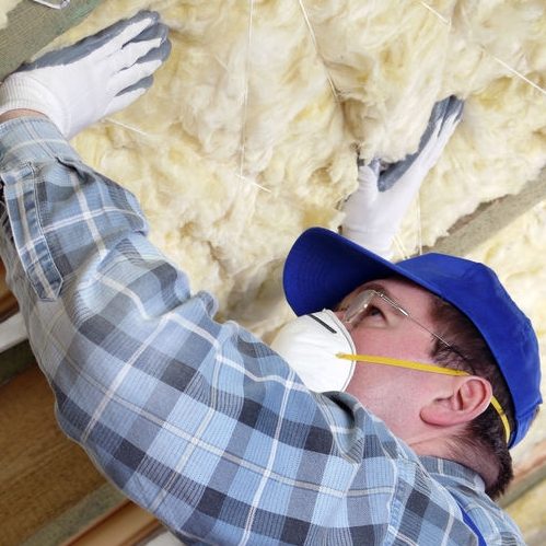 A Picture of a Man Insulating a Roof Using Mineral Wool.