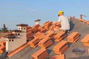 roofer installs tile roof